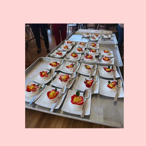 Bulk mini pavlova cake order with dozens of trays in production, perfect for catering events, weddings, or holidays