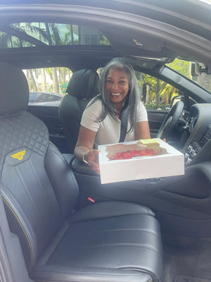 Midtown Miami pavlova cake customer holding a box showcasing CakeMiami’s fresh pavlova cake options