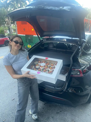 Woman showing off fresh pavlova cupcakes near me from CakeMiami in Midtown Miami, ready for local pickup