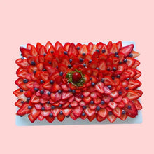 Large pavlova cake decorated with strawberries and blueberries in a layered flower pattern, 19-inch rectangular shape for events or celebrations