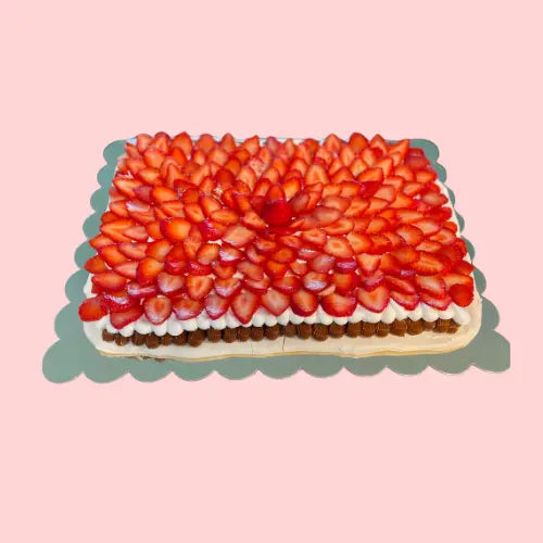 Large pavlova cake topped with fresh strawberries on whipped cream and dulce de leche, designed in a 19-inch rectangle shape for events or gatherings