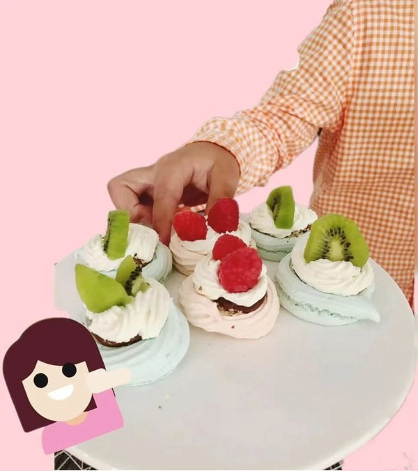 Mini pavlova cake being placed by hand, perfect for kids’ parties or interactive dessert stations with fresh fruit toppings