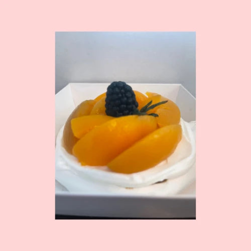 Mini pavlova cake topped with mango slices and blueberry, a tropical variation perfect for summer parties or gifting