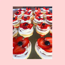 Display of mini pavlova cakes with strawberries stacked vertically for large events or corporate catering