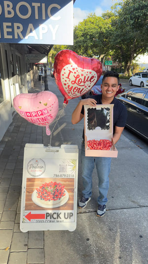 Happy customer with a box of fresh pavlova near me at the Coral Way location of Pavlova Bakery in Coral Gables, Miami